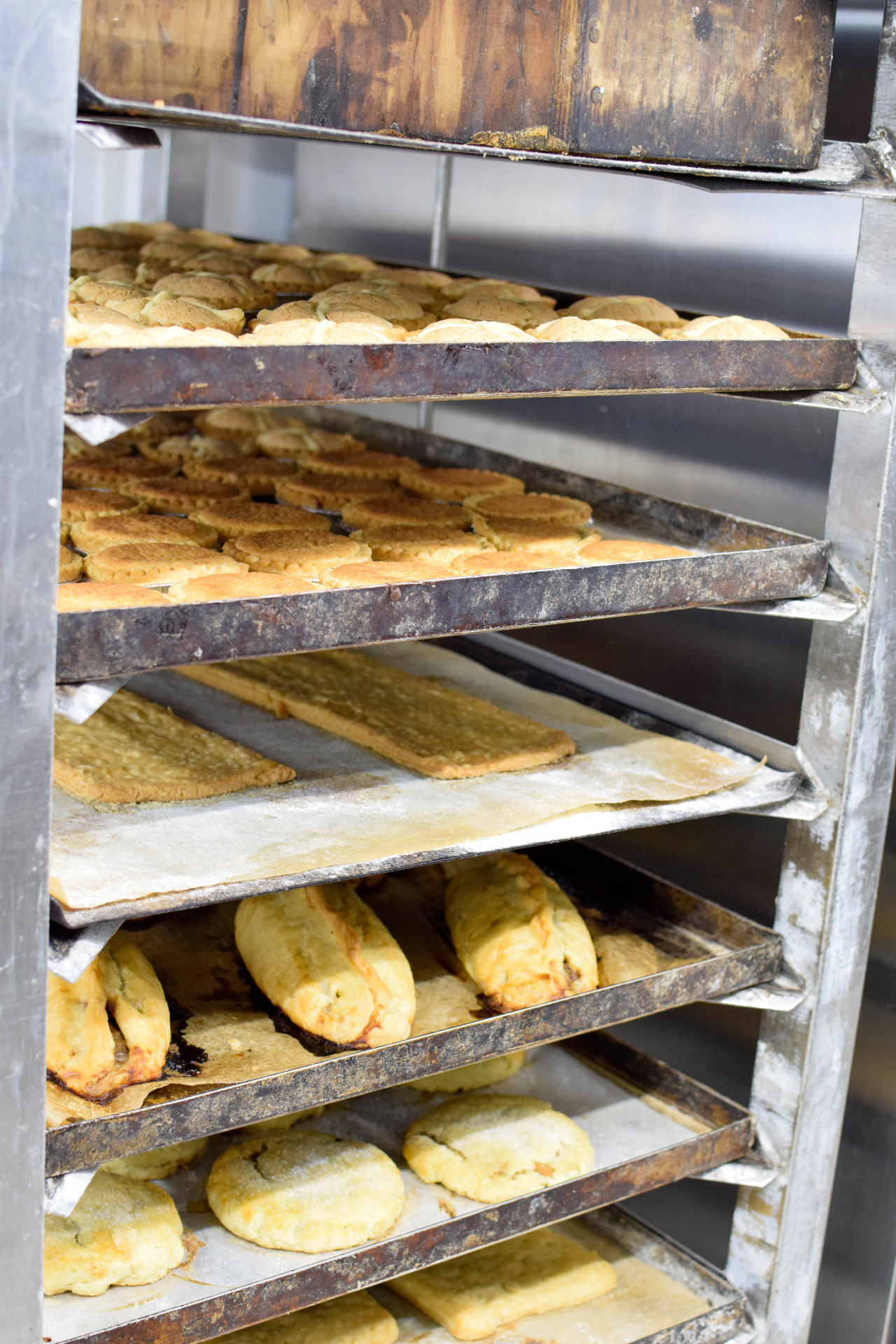 Racks of gluten free tarts and pastries cooling in the bakery