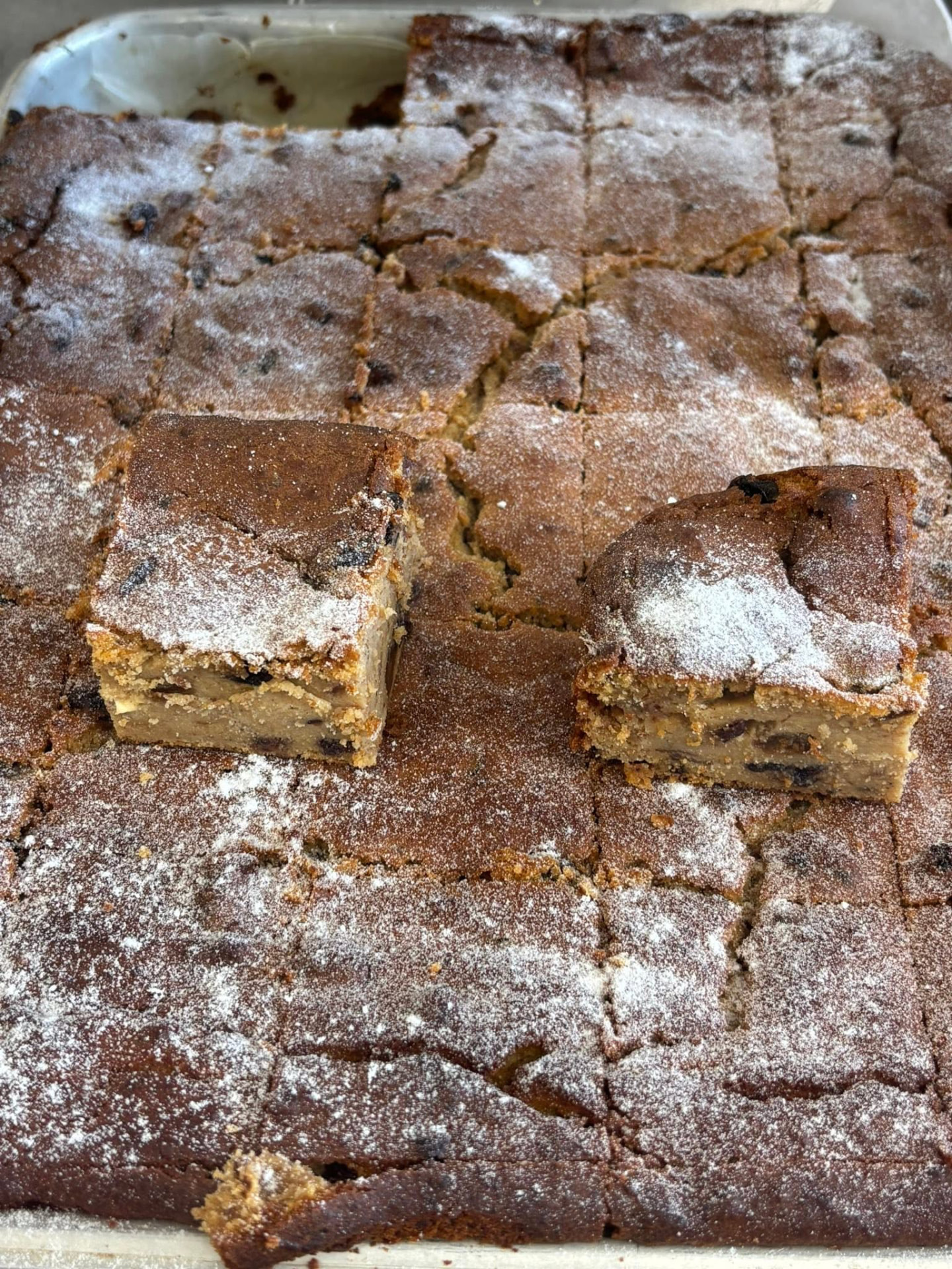 Tray of gluten free fruit slice dusted with icing sugar